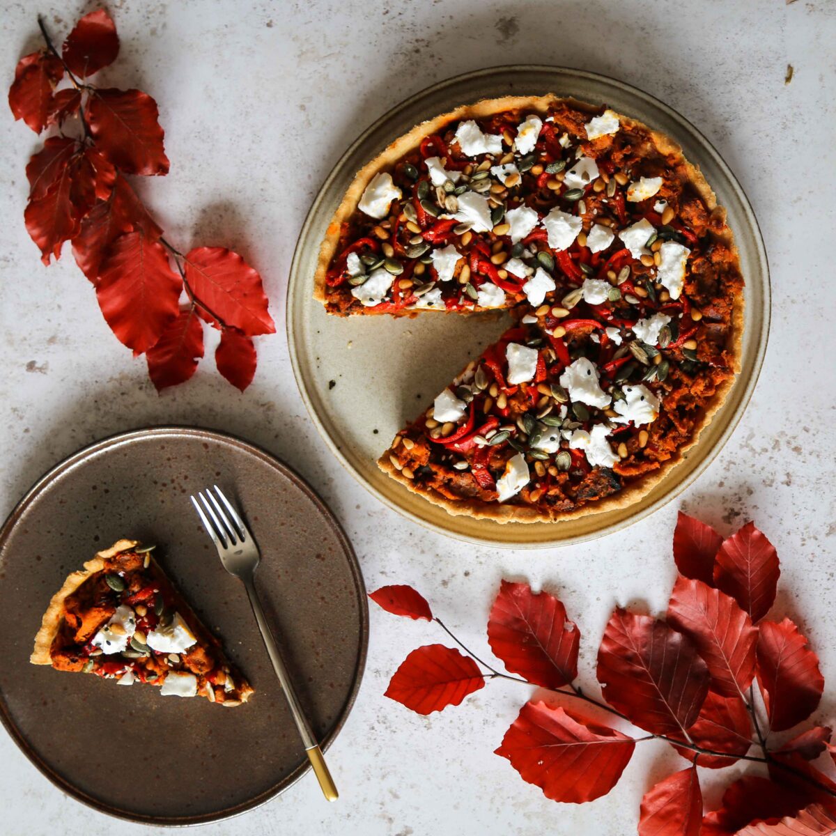Overhead shot of an autumn tart with leaves used as props